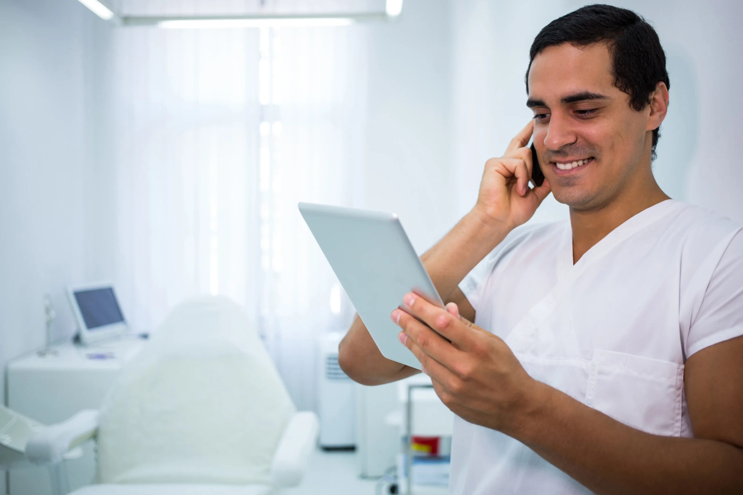 doctor-holding-digital-tablet-while-talking-mobile-phone